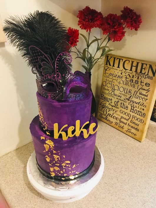A custom, purple, two-layer masquerade cake by Qiara Houston.