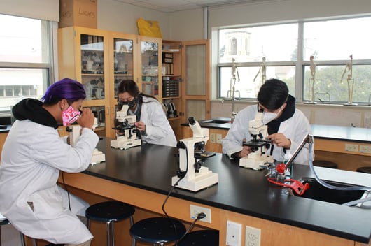 SJND science class with microscopes